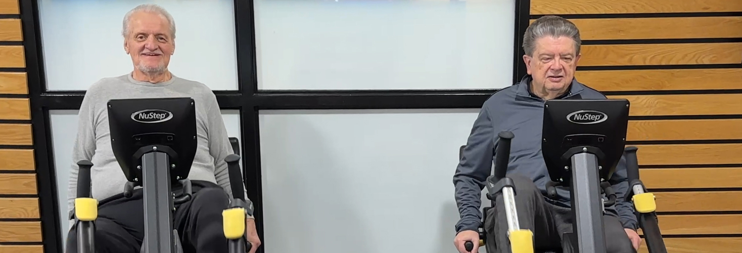 Two members using step bikes