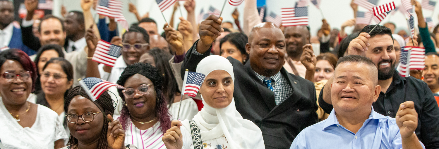 Group of people waving American flags