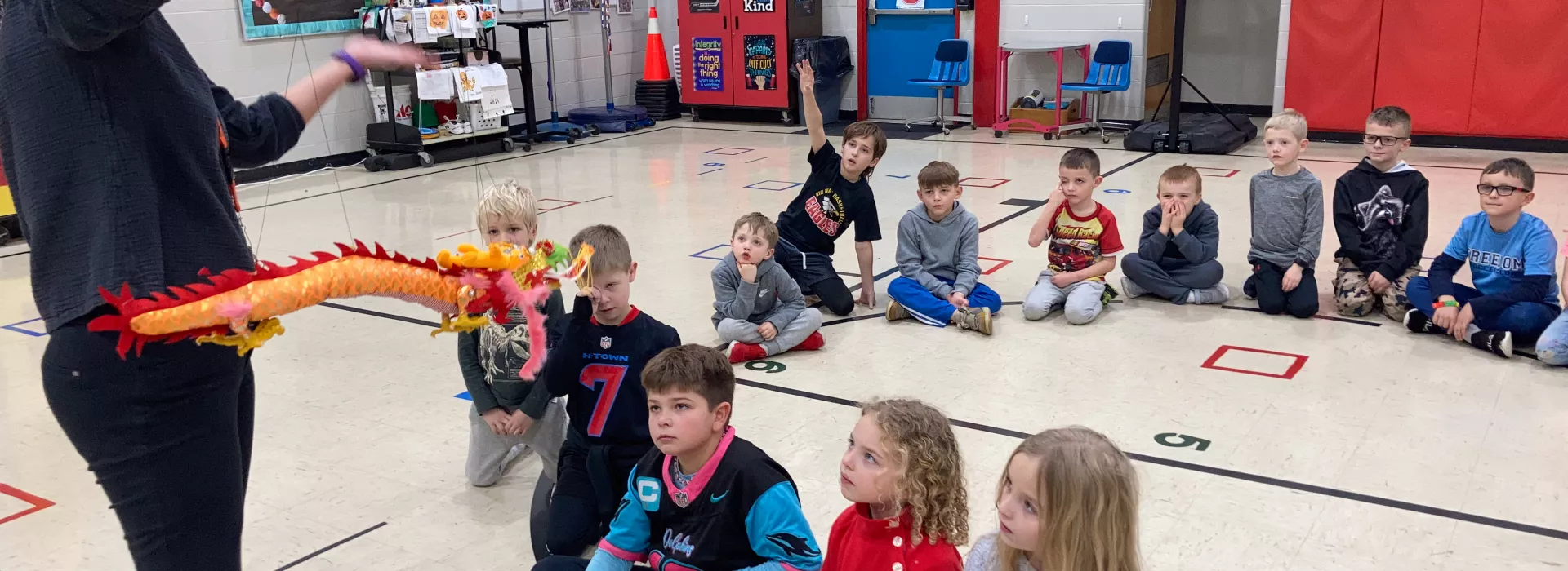 Group of students at Y-Club with staff showing an art project