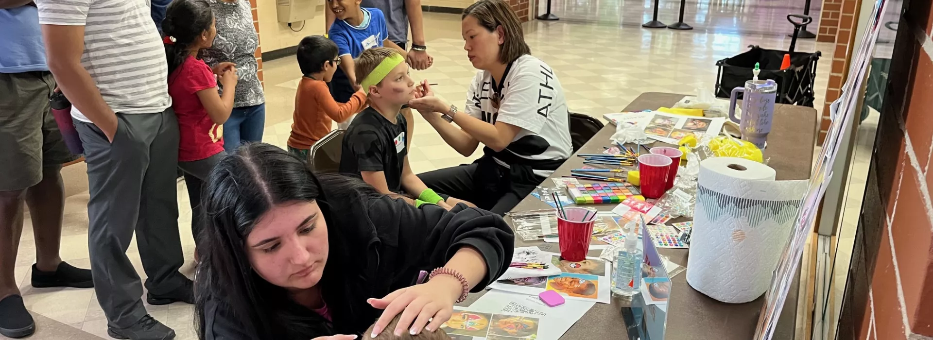 Staff face painting with kids